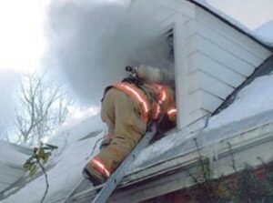 firefighter climbs through window