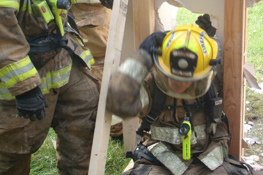 Firefighter breaches wall