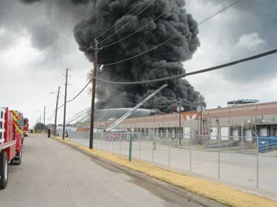 (1) The fire scene looking north from the south end of the warehouse along Dan Morton Drive.