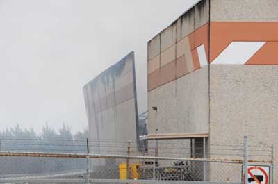 (2) This view of the north exterior wall shows the one missing wall panel that was sucked into the building before the fire department arrived.