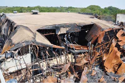 (7) The fire/explosion started in the Class 3 oxidizer storage room at the far left of the photo, moved around the Class 1 oxidizer storage room at the center, and quickly moved to the rest of the warehouse at the far right.