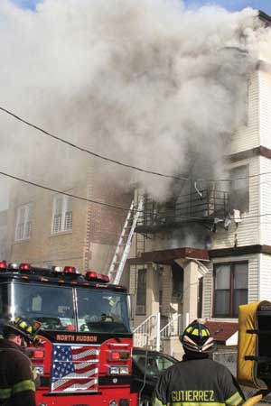 (3) Scene assignments dictate critical activities that must be performed on the fireground. Roof ventilation must be a priority at every fire in flat-roofed buildings. Here, the building is choking on itself because the first-arriving ladder did not open the roof. If you as an officer think any position is more important in this type of building, you will probably have a tough time making this building behave. (Photo by Ron Jeffers.)