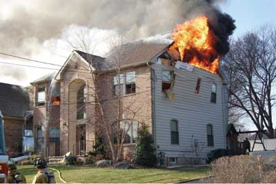 (10) Fire is venting from the D side of the structure since the delta wall has been displaced, along with the ceiling on the floor below, from the force of the blast in the attic space. (Photos 8-10 by Keith Addie, <a href=