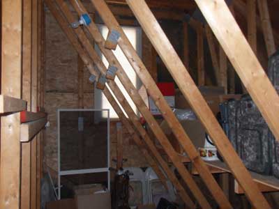 (5) A look through the door shows that attic trusses have been compromised by the occupant; the webs were cut away to facilitate storage in this area. The truss assembly is no longer under designed load, which can result in early catastrophic failure, especially in a fire.