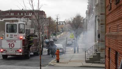 (4) The arrival of the truck company: Four firefighters dismount and ready themselves for truck work. The limited staffing brings attention to how the company can work effectively but balance the risk of working separately from the company officer. (Photo by Nick Eid.)