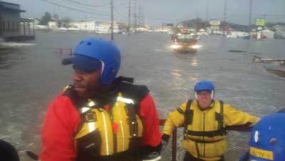 (3) Members of the NJ-TF1 swift water component making their way north on Route 35 in Ortley Beach. 