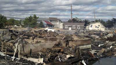 (6) One of the more than 30 structures that burned in the Camp Osborn section of Brick Township on the barrier island. Occurring during the height of the storm, these fires were suspected to be caused by gas leaks. Fire units were unable to access the barrier island because of the flooding and washed-out roads.