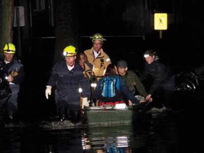 (1) VA-TF1 personnel aided New Jersey rescue personnel in rescuing stranded victims within a block of the Little Ferry command post, depositing them on dry ground. No personal flotation devices were required since the water was only knee-deep at this point. [Photos courtesy of the Federal Emergency Management Agency (FEMA).]