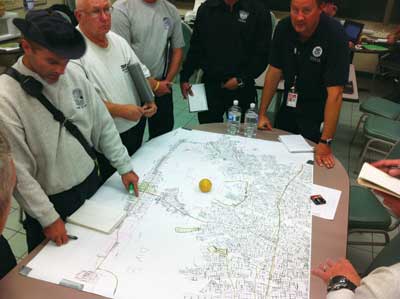 (9) IST member and US&R task force leaders map Nassau County search areas.