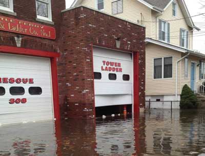 (4) Three days after the storm. This firehouse is approximately one quarter of a mile from the Hackensack River. The water did not recede for another two days and reached 4½ feet deep inside the firehouse.