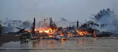 (2) Multiple house fires on a single block were common for many fire departments along the barrier island and the mainland. This fire began in the house to the far left and quickly spread to four adjacent structures. 