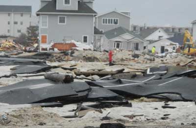 (3) A typical residential roadway on the barrier island immediately after the storm. With roadways crumbled, local fire departments were unable to maneuver apparatus close to collapsed or burning structures. Access to structures was a major tactical concern.