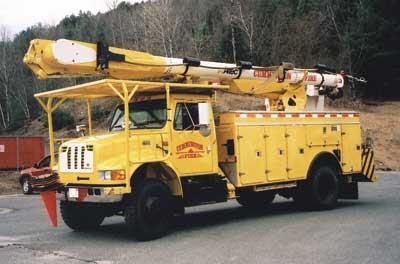 60-foot Altec 4 × 4 bucket truck features a large 2½-inch nozzle fed by a 2½-inch line, a heavy-duty winch for rescue work, and a breathing air line