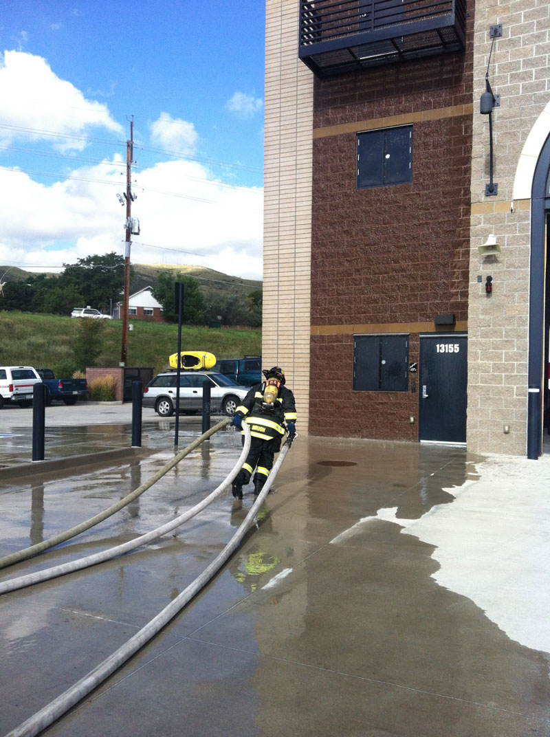 A firefighter moves a hoseline.