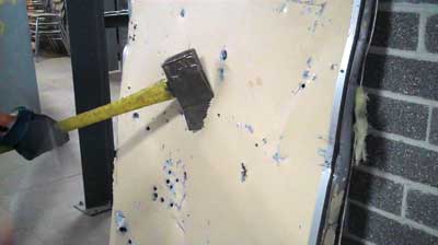 ax blade is buried too deep into the door; this causes additional friction while cutting.