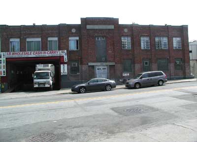 parapet of this storage warehouse conceals a saw-tooth roof.