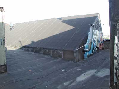 This saw-tooth roof has a bay that abuts on an exterior wall..