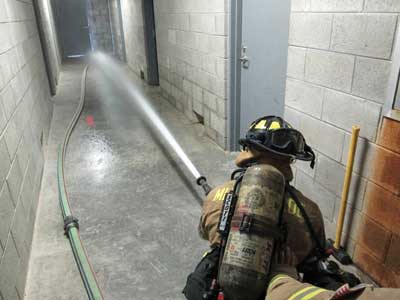 nozzle is flowed and the pressure adjusted before opening the door to the fire apartment