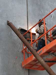 (1) Steel is arc welded to the steel embedded in the tilt-up wall sections.