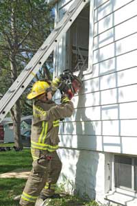 (1) The chain saw is used to cut a higher window to assist in a removal operation J.J. Cassetta