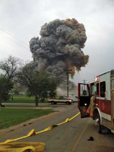 (5) The explosion from the vantage of West Volunteer Fire Department's Engine 1. Note the noncharged supply line to the left that was part of the original forward lay that was never completed or charged.