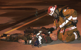 (2) A recruit drills on a Mayday response. (<i>Photo by Rayford Smith.</i>)