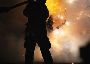 (4) A recruit extinguishes a car fire. (<i>Photo by Rayford Smith.</i>)