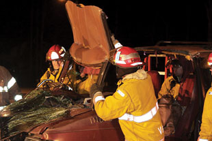 (5) A crew practices vehicle rescue operations. (<i>Photo by Rayford Smith.</i>)