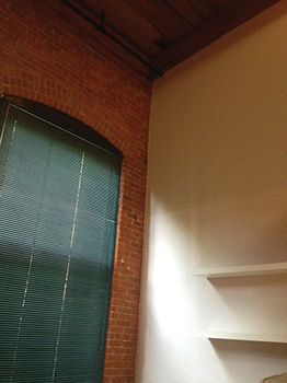 Inside an apartment; the newly framed walls and gypsum board create a separation between living units.