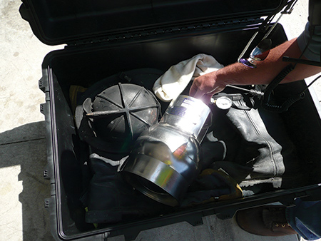 (1) Enclosure used by NIOSH to sample off-gassing PPE ensembles. After closing the lid, the metal canister collected VOCs for analysis. (Photo courtesy of the National Institute for Occupational Safety and Health.)