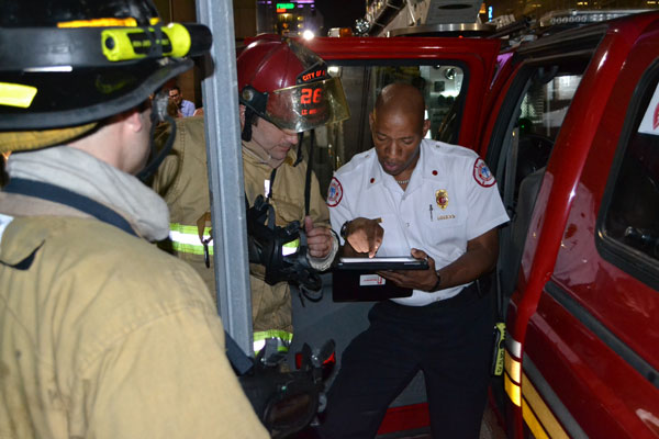 An officer supplies firefighters with information on the task at hand.