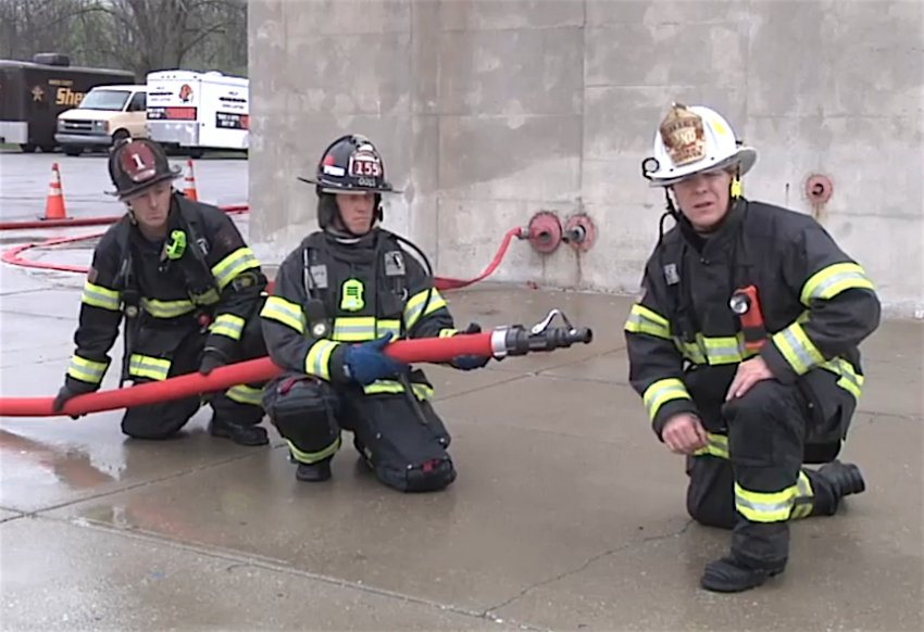 Dave McGrail with firefighters on a hoseline