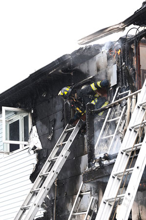 (5) A member operating on the interior of the fire building was trapped by the intensifying fire and collapse of the top-floor ceiling. He made his way to a window and prepared for a head-first ladder slide.