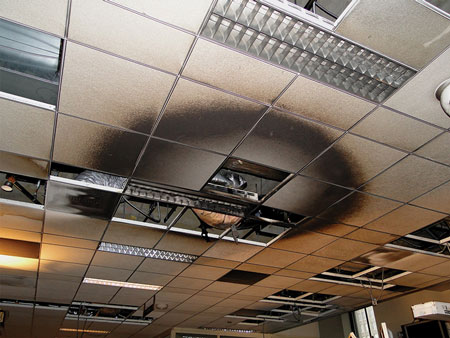 (7) A circular pattern on ceiling tiles directly above where a fire originated.