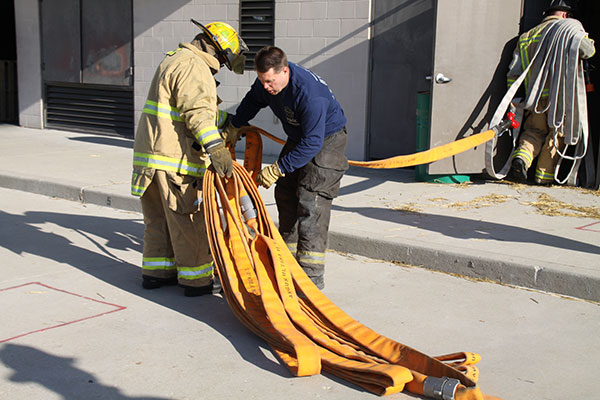 Firefighters praticiing flaking out hoselines during training evolutions.