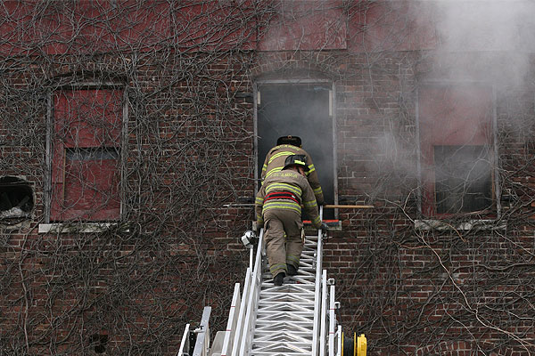 Firefighters ascend an aerial ladder during a training evolution.