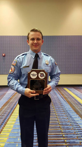 Firefighter Jeremy Deins with the award