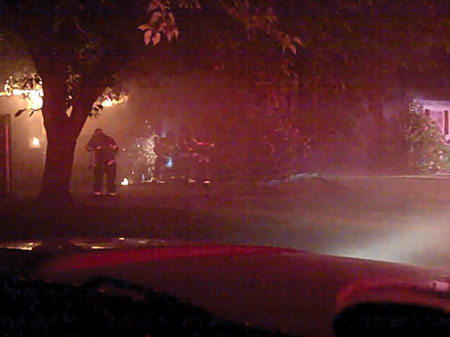 (1) The view of a house fire at night from the command post. Smoke, darkness, trees, and apparatus made it difficult the see the home. The fire was heavy in the rear. The second battalion chief was assigned Division A; all interior companies reported to him. (Photos by author.)