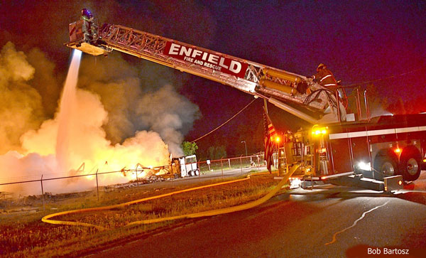 Enfield aerial device pours water on a fire in a large structure.