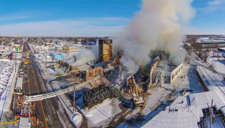 (4) In this view, the grappler is demolishing parts of the structure to gain safe access to the seat of the fire. The IC can watch this operation live and make sure his personnel and equipment are safe.