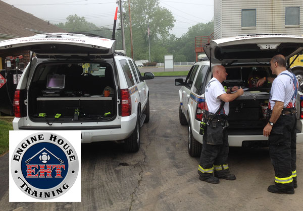 Mirrored command vehicles at an incident scene.