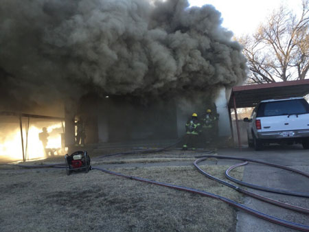 (6) Heavy smoke emanates from around the roof area. High heat in the structure indicates there is fire in the void spaces.