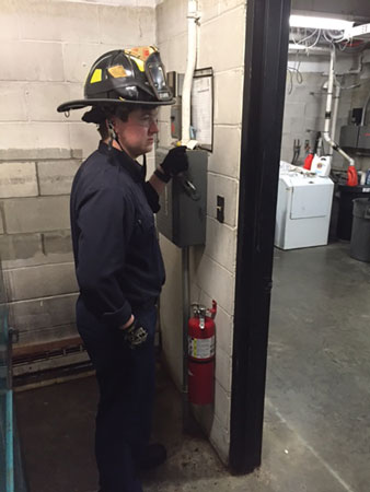 (3) The firefighter is killing the power safely. (4) Lockout/tagout tags indicate the power has been shut off.