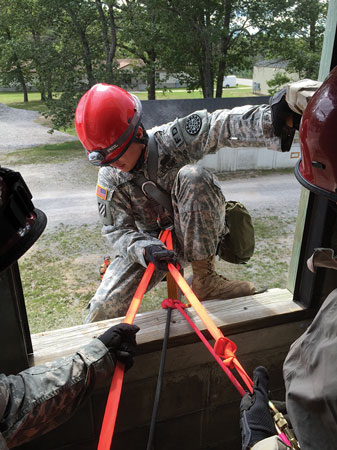 (4) This United States Army rescuer is being assisted onto the rope system with a 25-foot webbing that is run through his D ring.