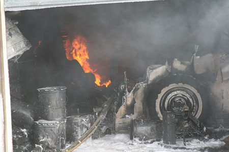 (2) The unknown hazards may include these five-gallon cans of flammable liquid to which foam was applied. [Photo courtesy of the Spokane (WA) Fire Department.]