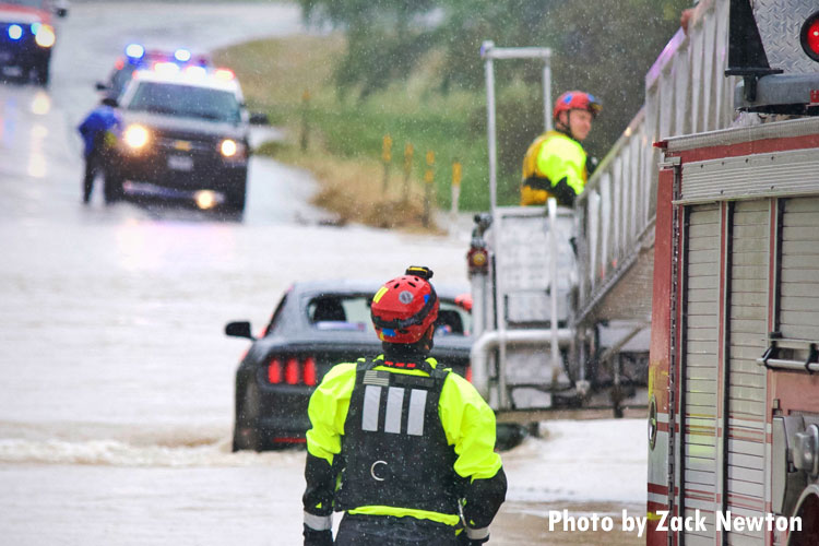 A member of Rescue 11 watches as the last victim is loaded into the bucket of Platform Ladder 11.