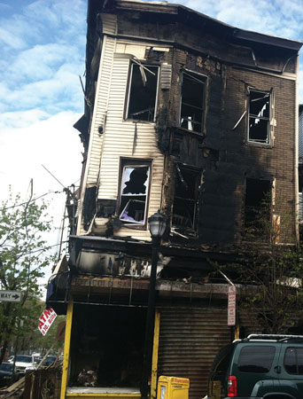 (1) The structural carcass. This braced-frame building was gutted from an overnight fire and was also leaning. Personnel and apparatus were removed from the area while awaiting the demolition crew’s arrival. <i>(Photos 1-3 by author)</i>.