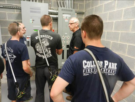 (1) Firefighters on a site visit to a new building are learning about its protection features and systems. <i>(Photos by author.)</i>