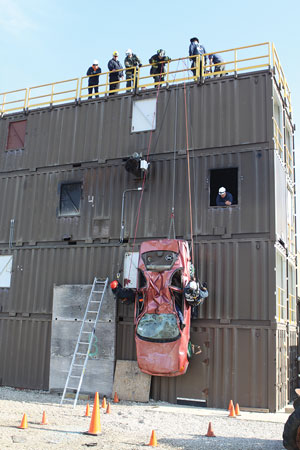 (1) The vehicle is suspended from the training tower. The safety ladder is placed alongside the structure, and the area below the training is cordoned off. (Photos by Tim Olk.) 