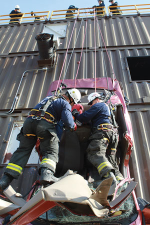 (7) Members remove the final victim from the vehicle. After this training is completed, participants critique the entire operation.